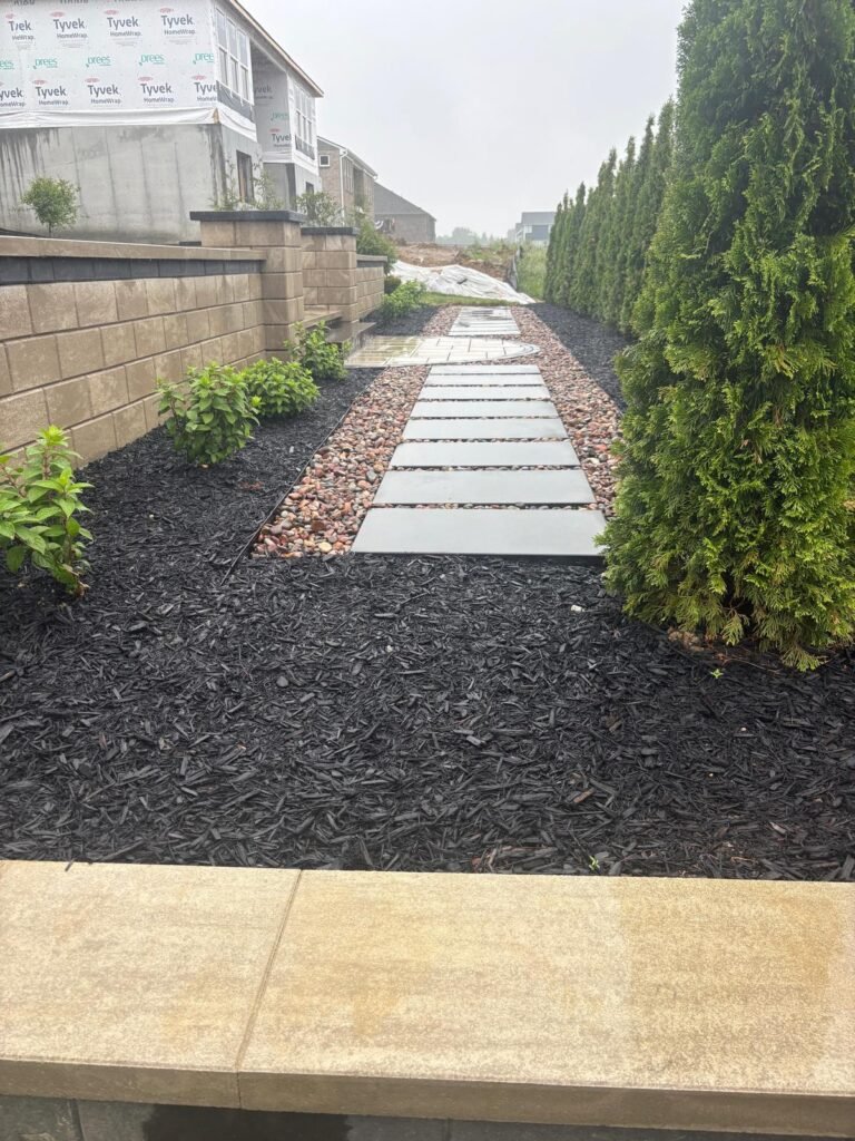 Beautiful custom retaining wall with decorative landscaping and walkway at a home in Fort Thomas, KY.